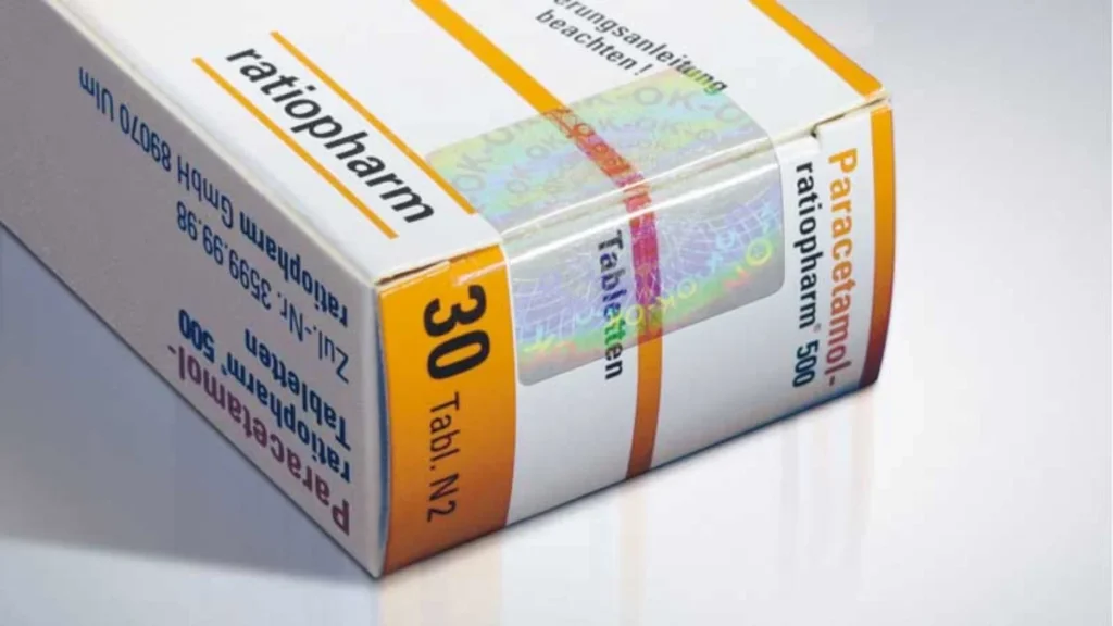A close-up of a ratiopharm Paracetamol 500 mg tablet box showing a security hologram seal on the carton, with dosage information '30 Tabl. N2' visible on the packaging.